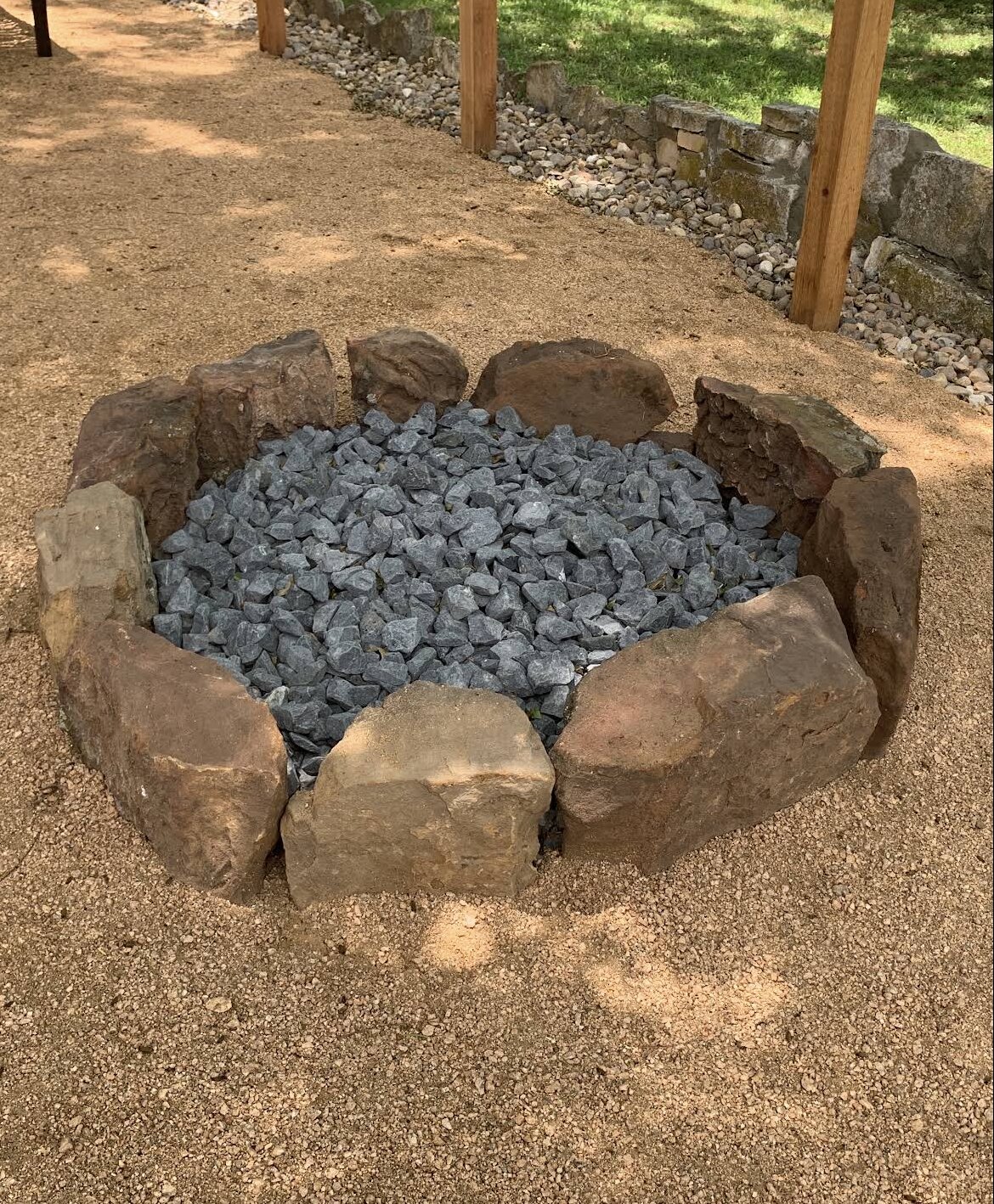 circular stone fire pit with crushed rock fill on decomposed granite