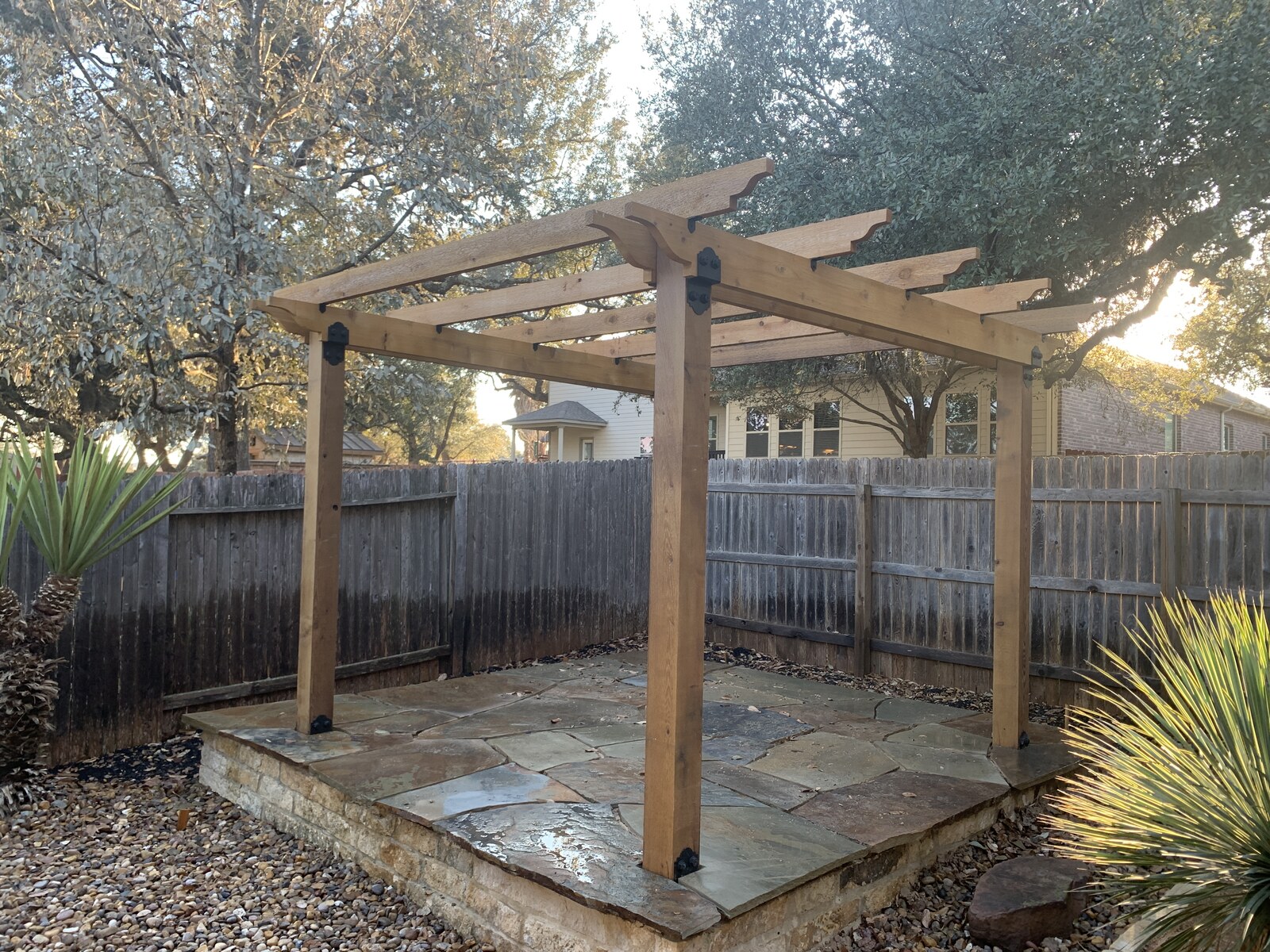 Wood pergola shade structure with patio and Hill Country landscaping — Texas Tough Landscapes